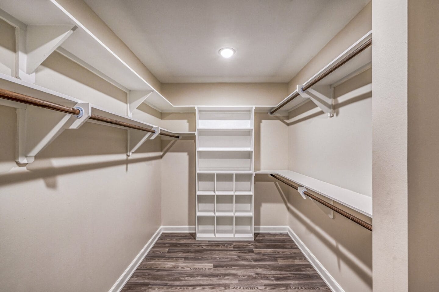 A spacious walk in closet with white shelves at The Sovereign at Regent Square, 3233 West Dallas, Houston, TX