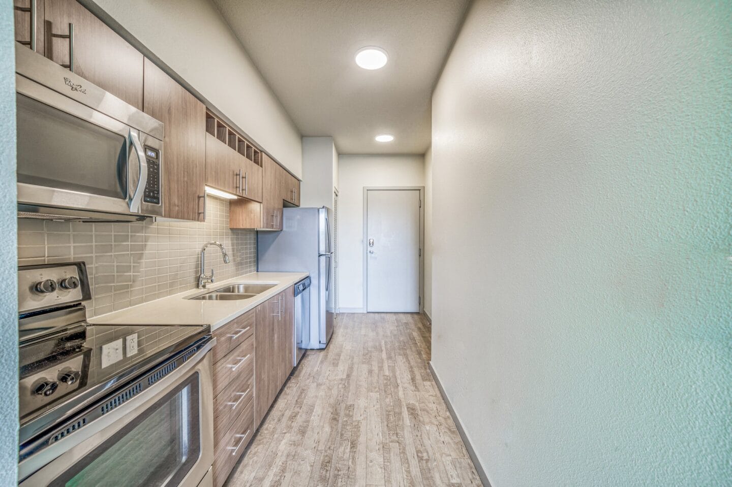 Kitchen with wooden cabinets and stainless steel appliances at Platform 14, Hillsboro, OR