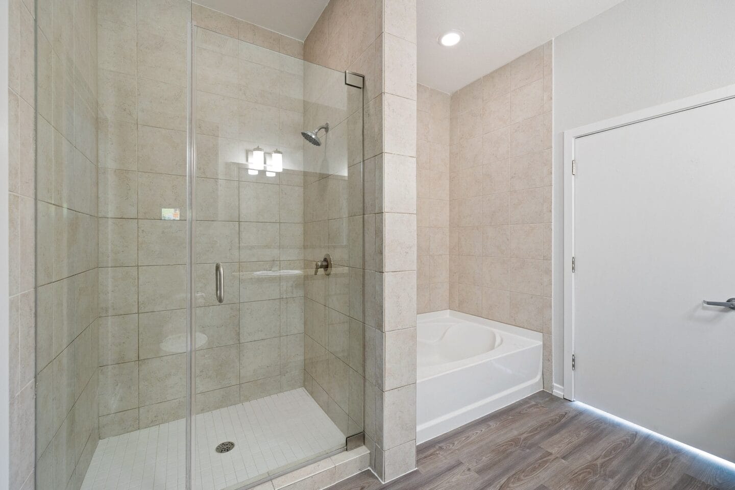 A bathroom with tiled walls and a glass shower stall The Monarch by Windsor, Austin, TX