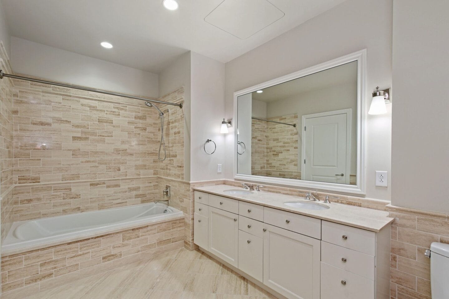 a bathroom with a tub and a sink and a mirror