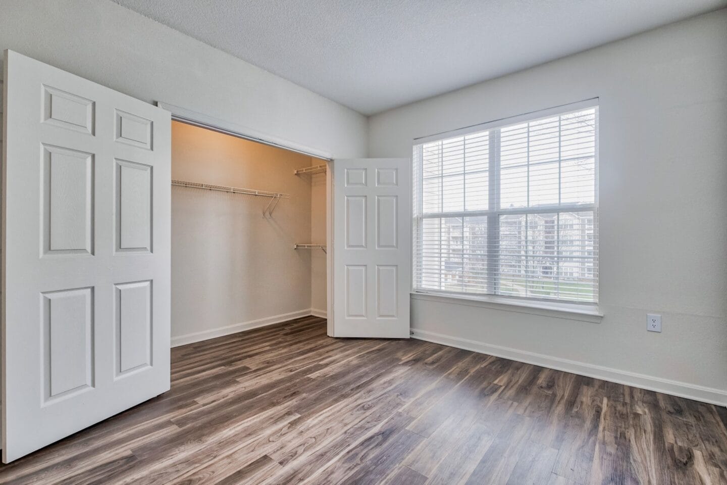 Bedroom with a closet and a large window at Windsor Herndon, Virginia, 20171