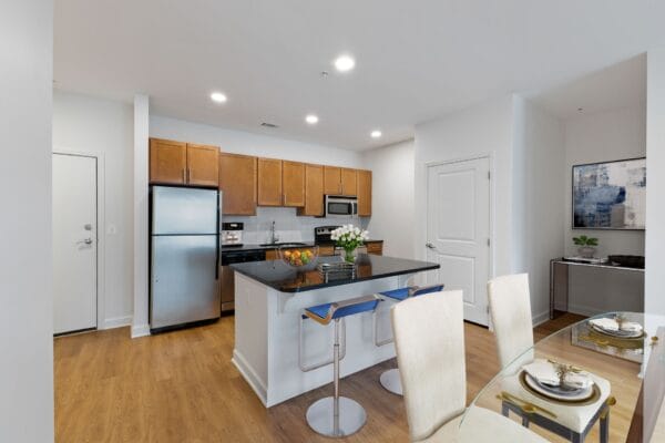 a kitchen and dining room with a blue island and stainless steel appliances