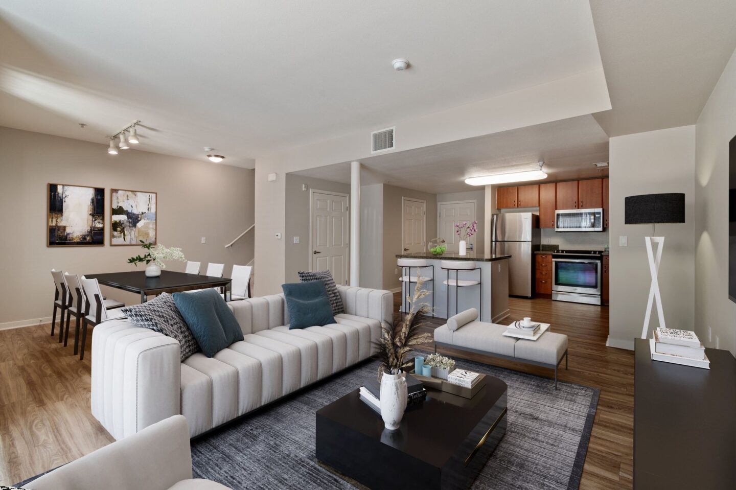 A modern living room with a white sofa and a coffee table.