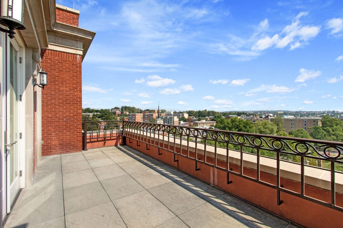 the view of the city from the balcony of an apartment building