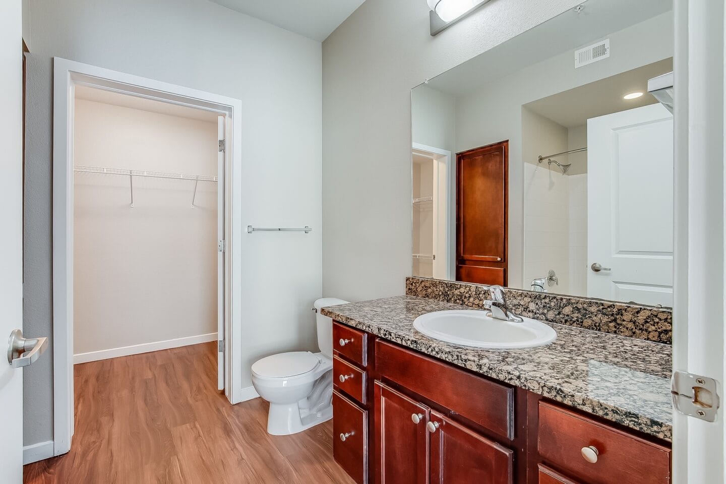 a bathroom with a sink and toilet and a mirror