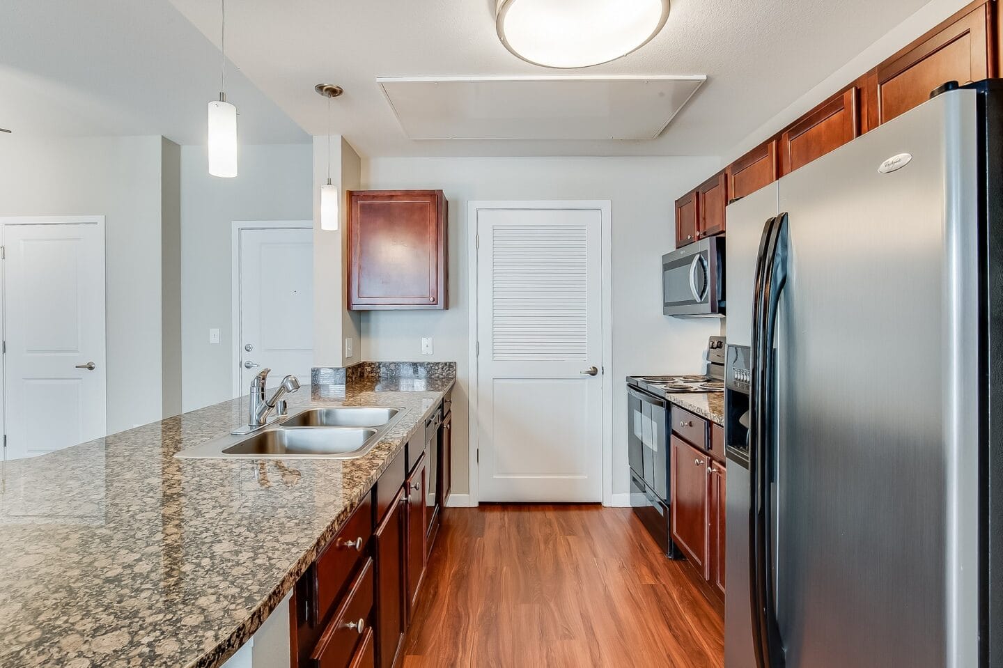 a kitchen with granite counter tops and stainless steel appliances