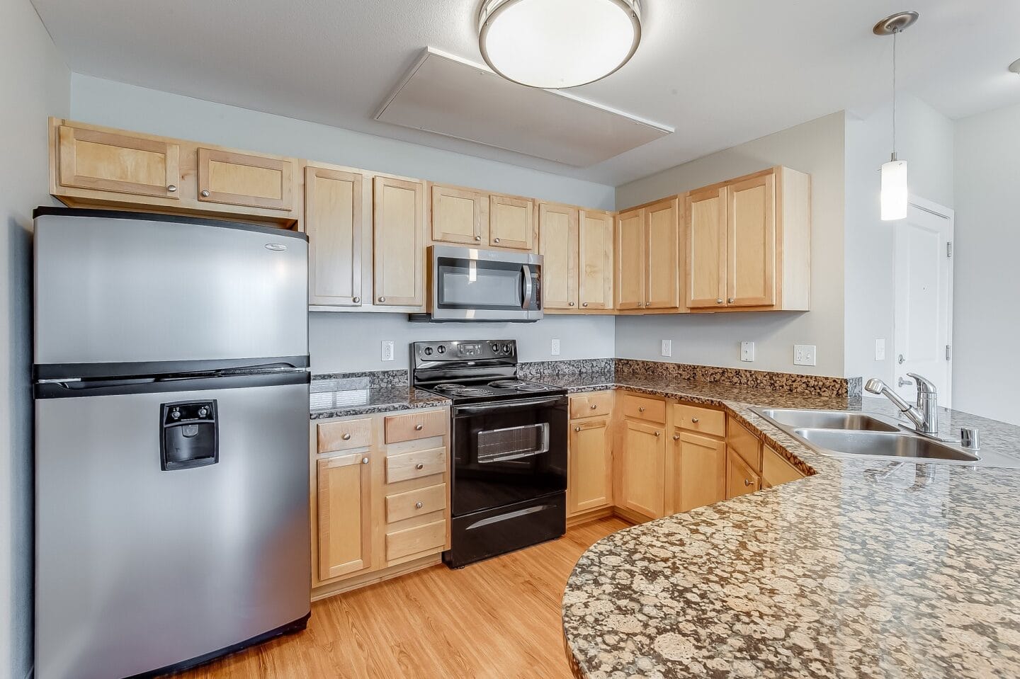 a kitchen with granite counter tops and stainless steel appliances