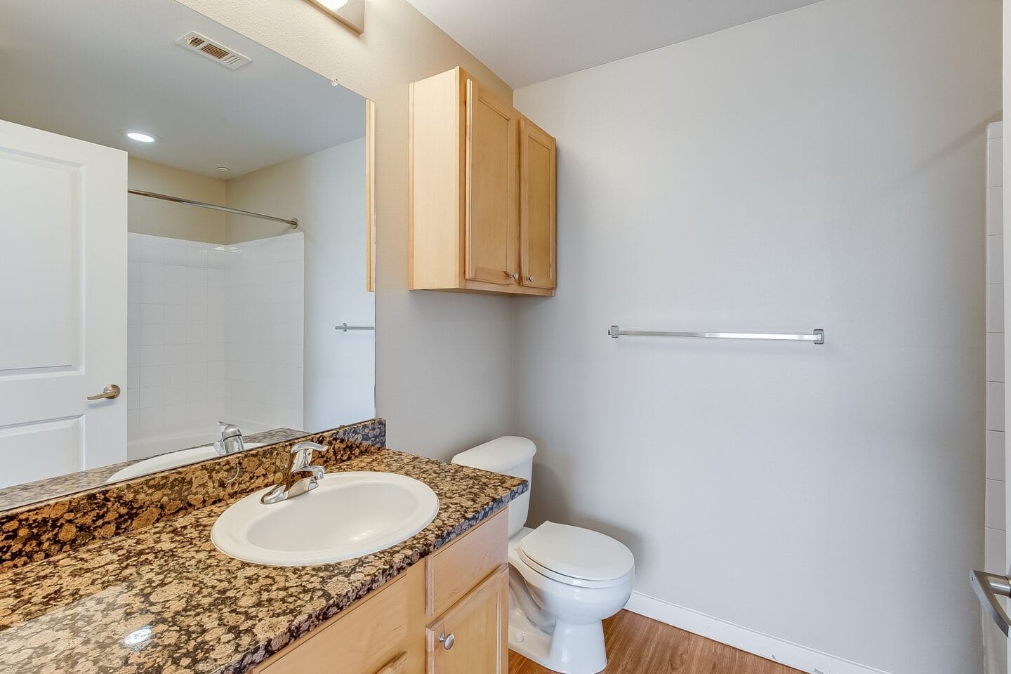 a bathroom with a sink and toilet and a mirror