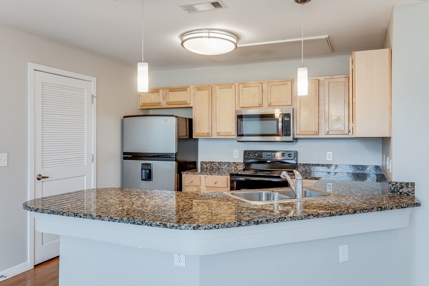 a kitchen with a granite counter top and a