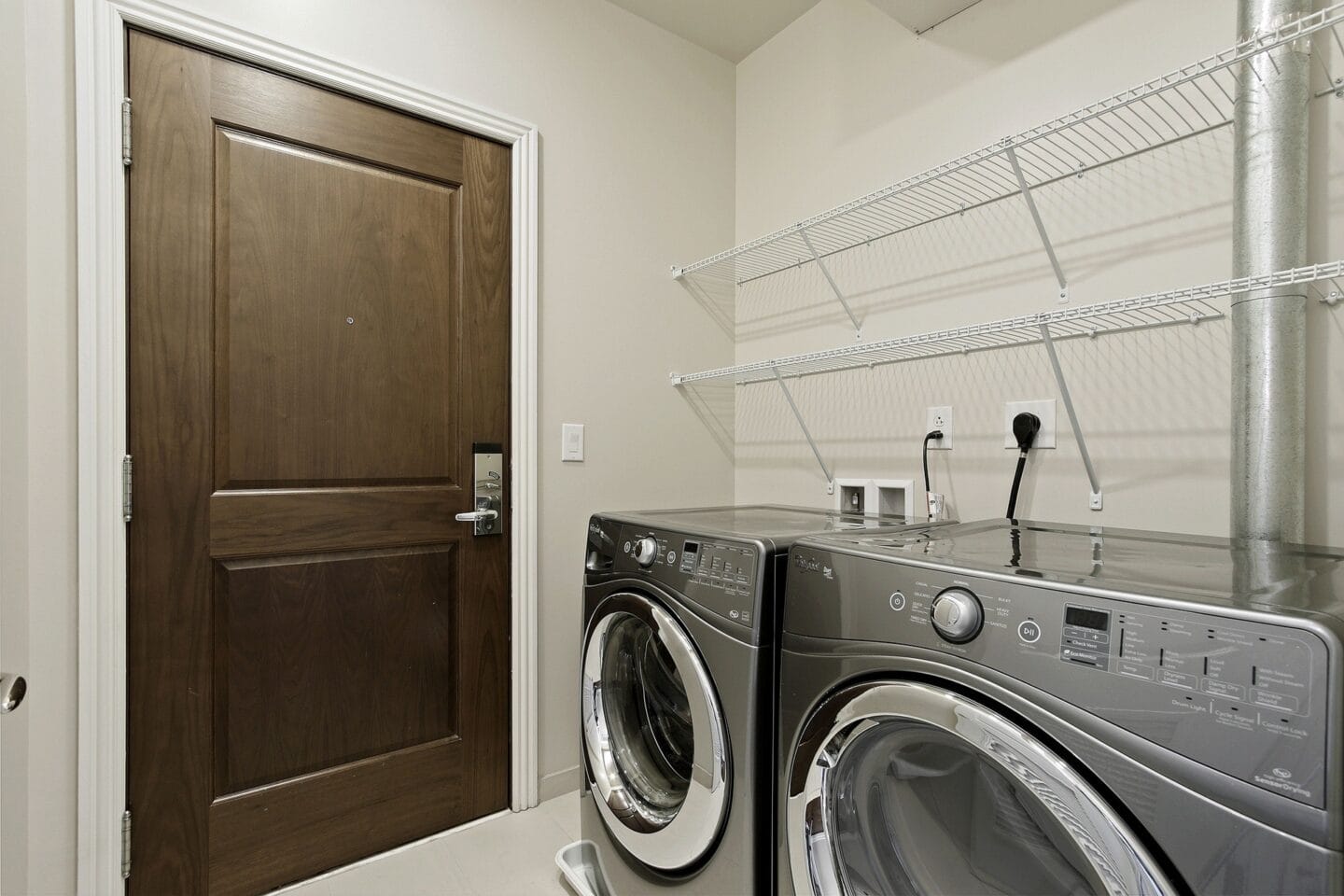 a laundry room with a washer and dryer and a closet with a door