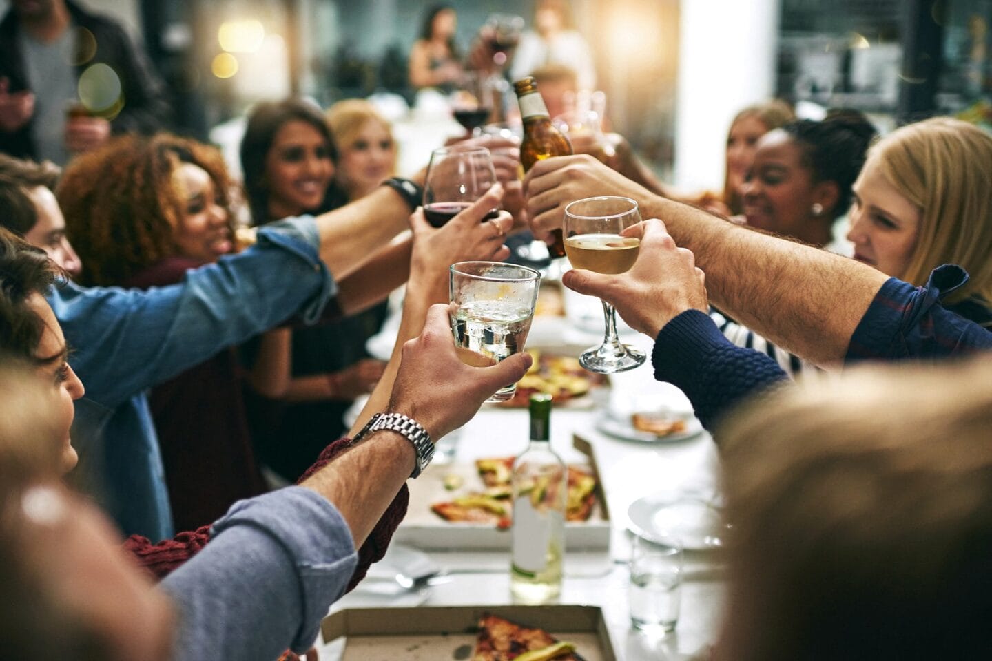 Friends toasting around table at Windsor Interlock, 2 Interlock Ave NW, GA