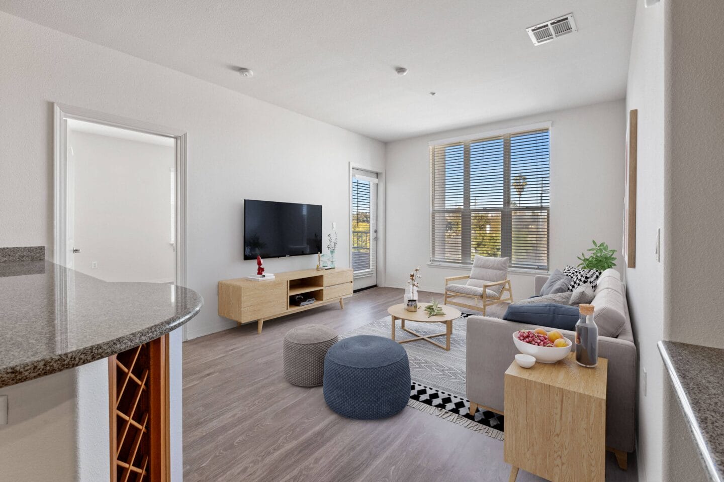 a living room with white walls and hardwood flooring