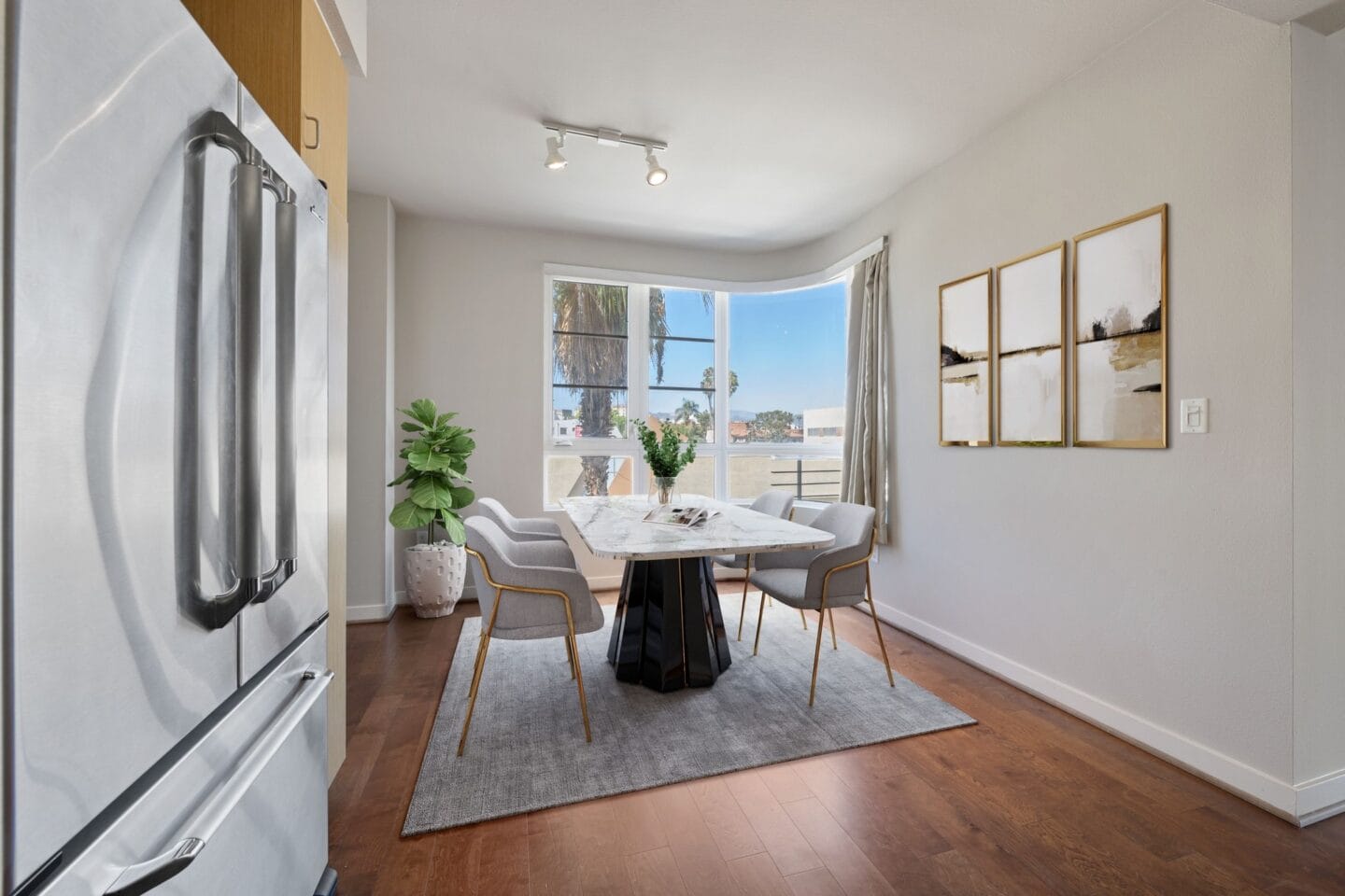 a dining room with a table and chairs and a window