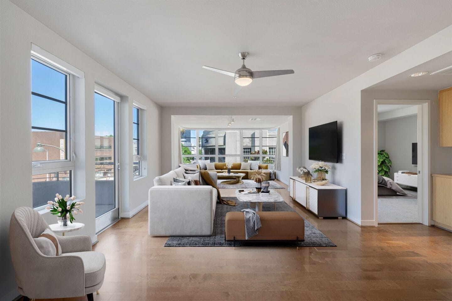 a living room with a couch and a table and a ceiling fan