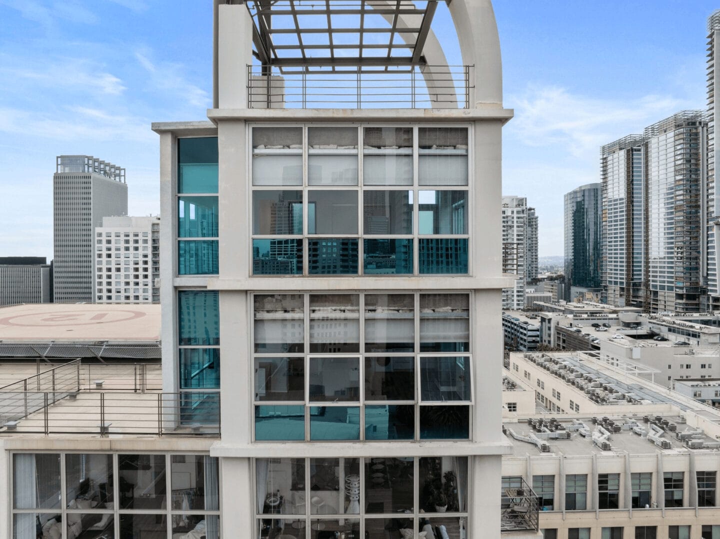 a tall white building with large glass windows and