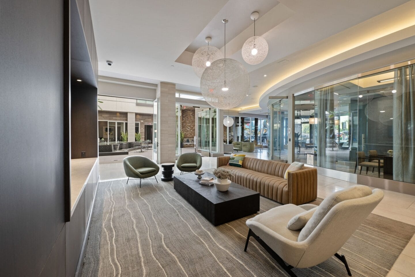 a lobby with a couch and chairs and a coffee table