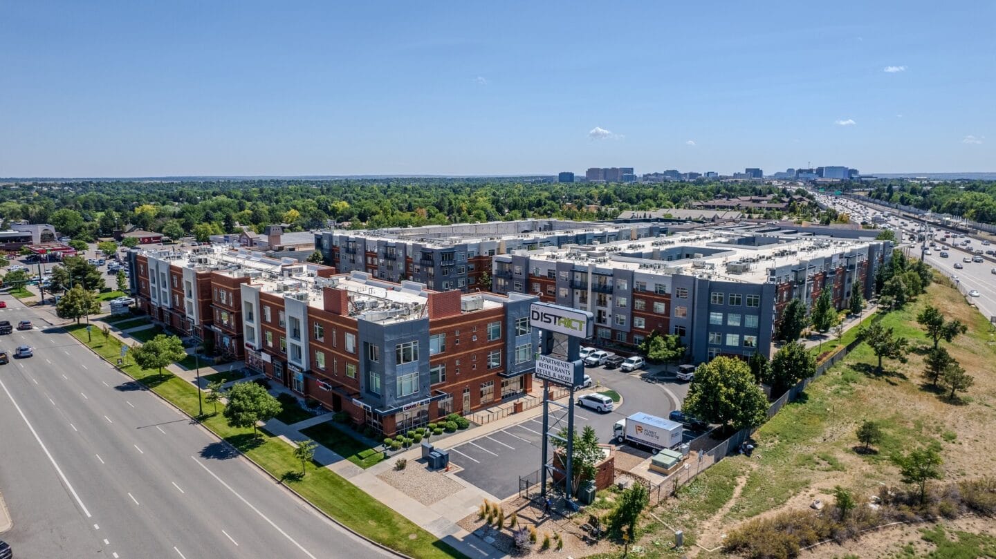 an aerial view of an apartment complex with a city in the background