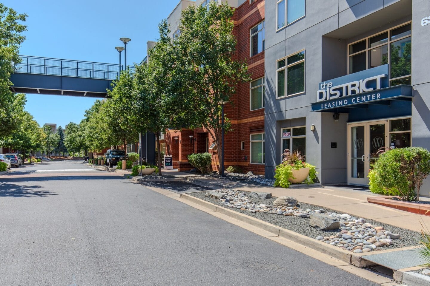 a street view of a building with a bridge over the street