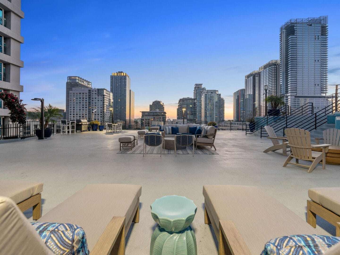 a large patio with tables and chairs and a view of the city