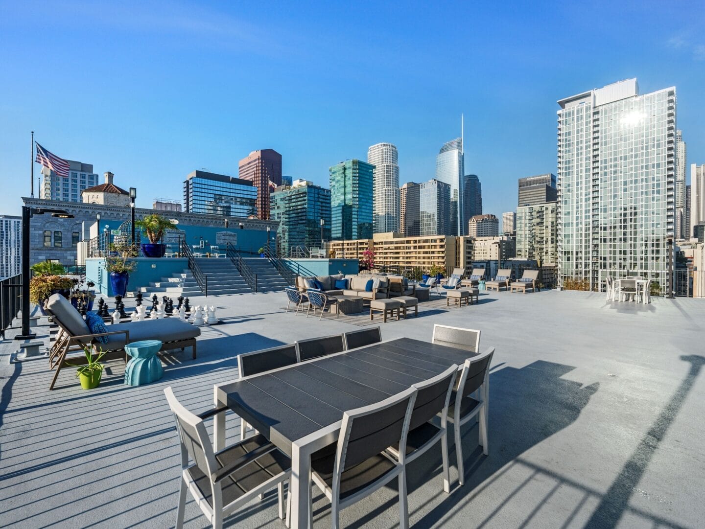 a roof deck with a table and chairs and a view of the city