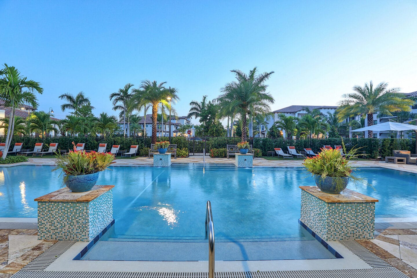 Lounge at the pool under our mature palm trees at Windsor at Delray Beach, Delray Beach,Florida