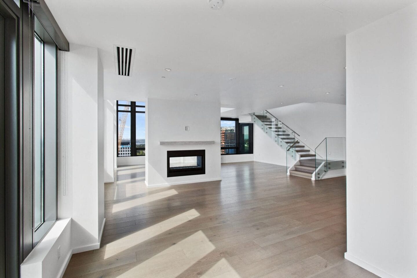 A large living room with white walls and hardwood floors at Bravern, Bellevue, Washington