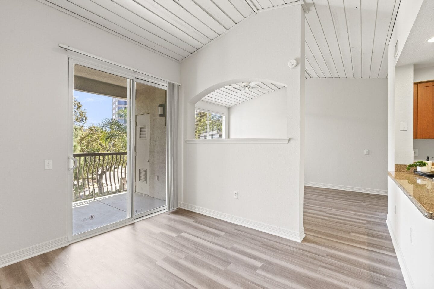 Living room and balcony at Windsor at Main Place, Orange, California