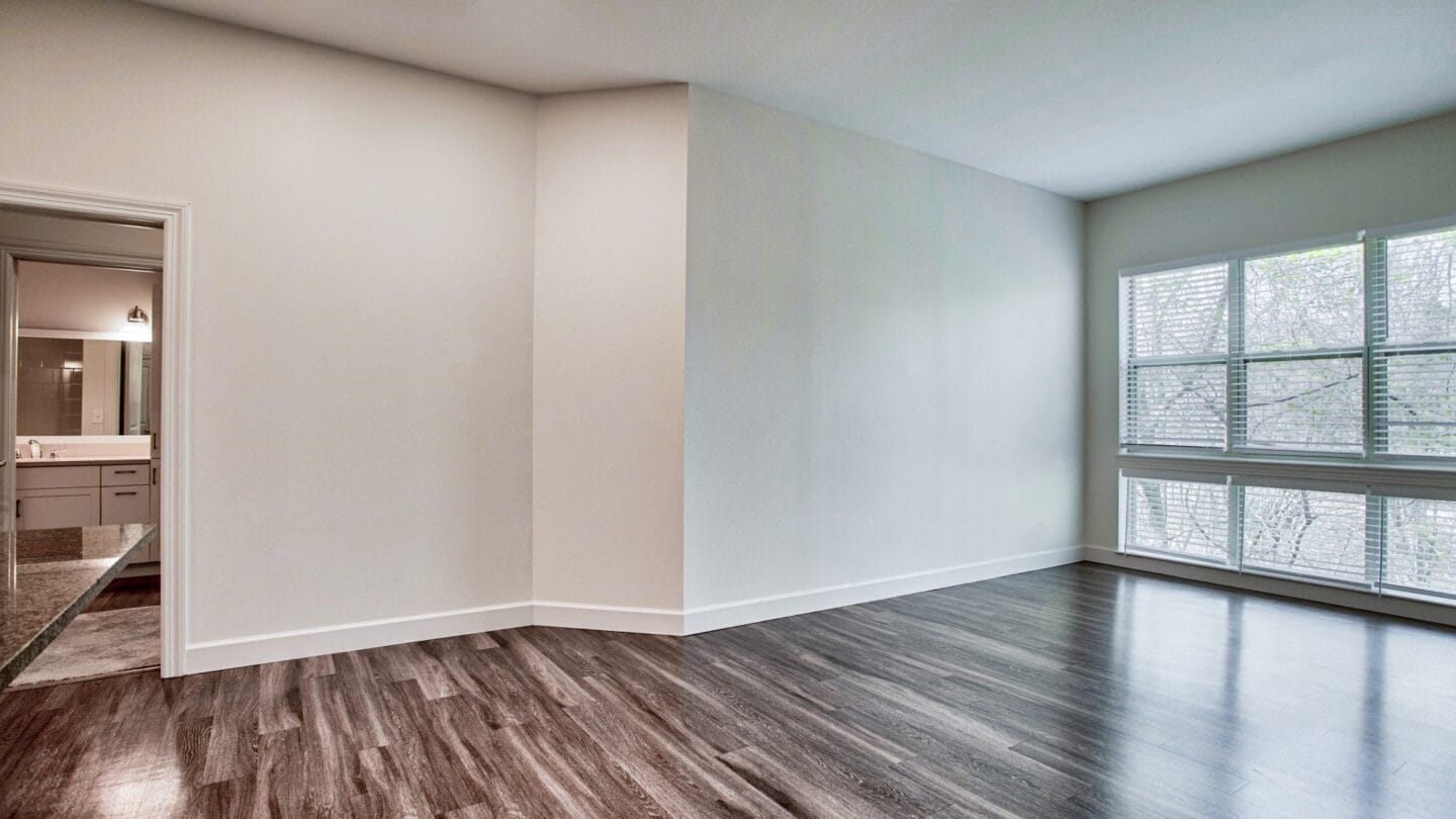 an empty living room with a large window