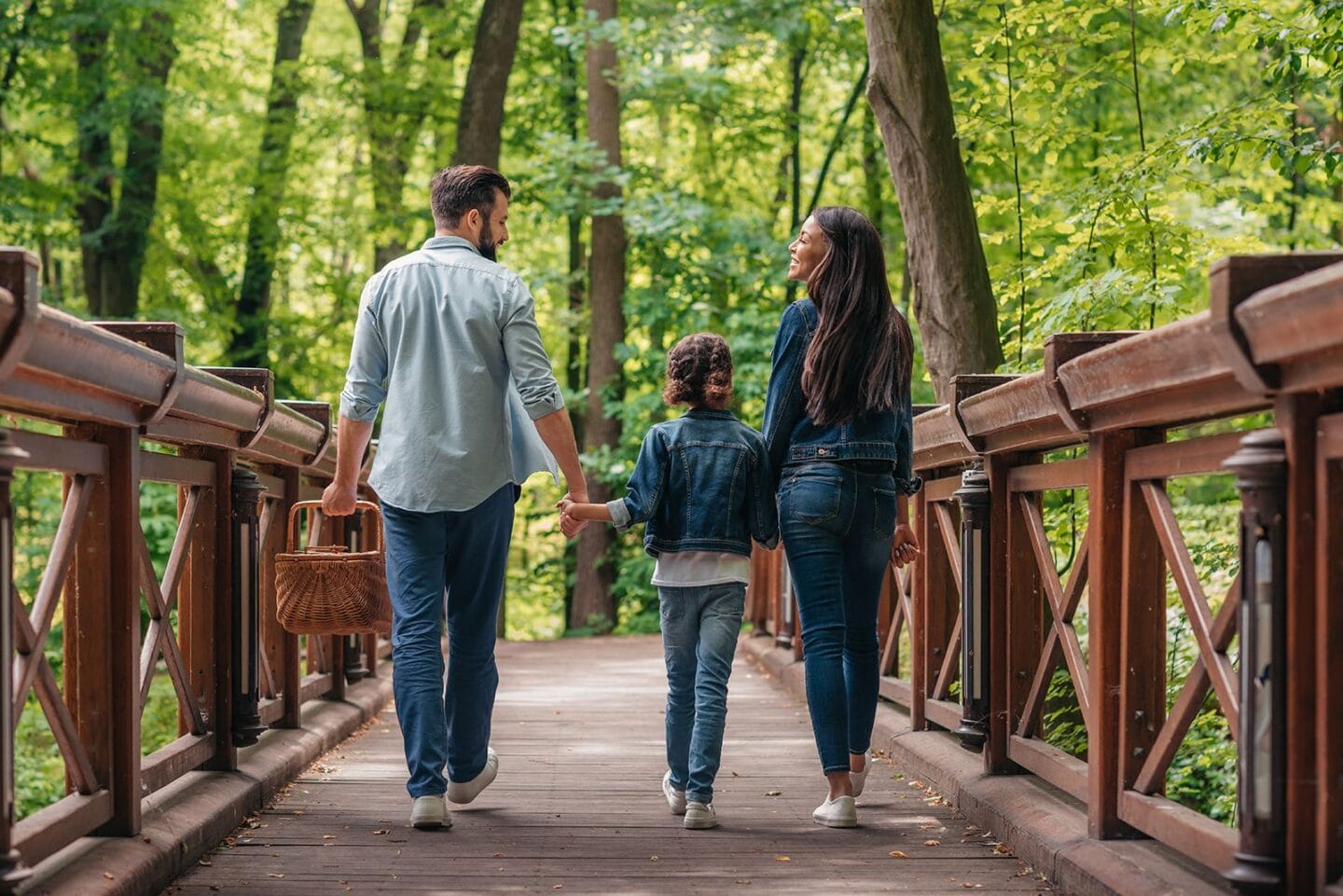 family walking in the woods across the bridge at Windsor Ridge, Austin, TX, 78727