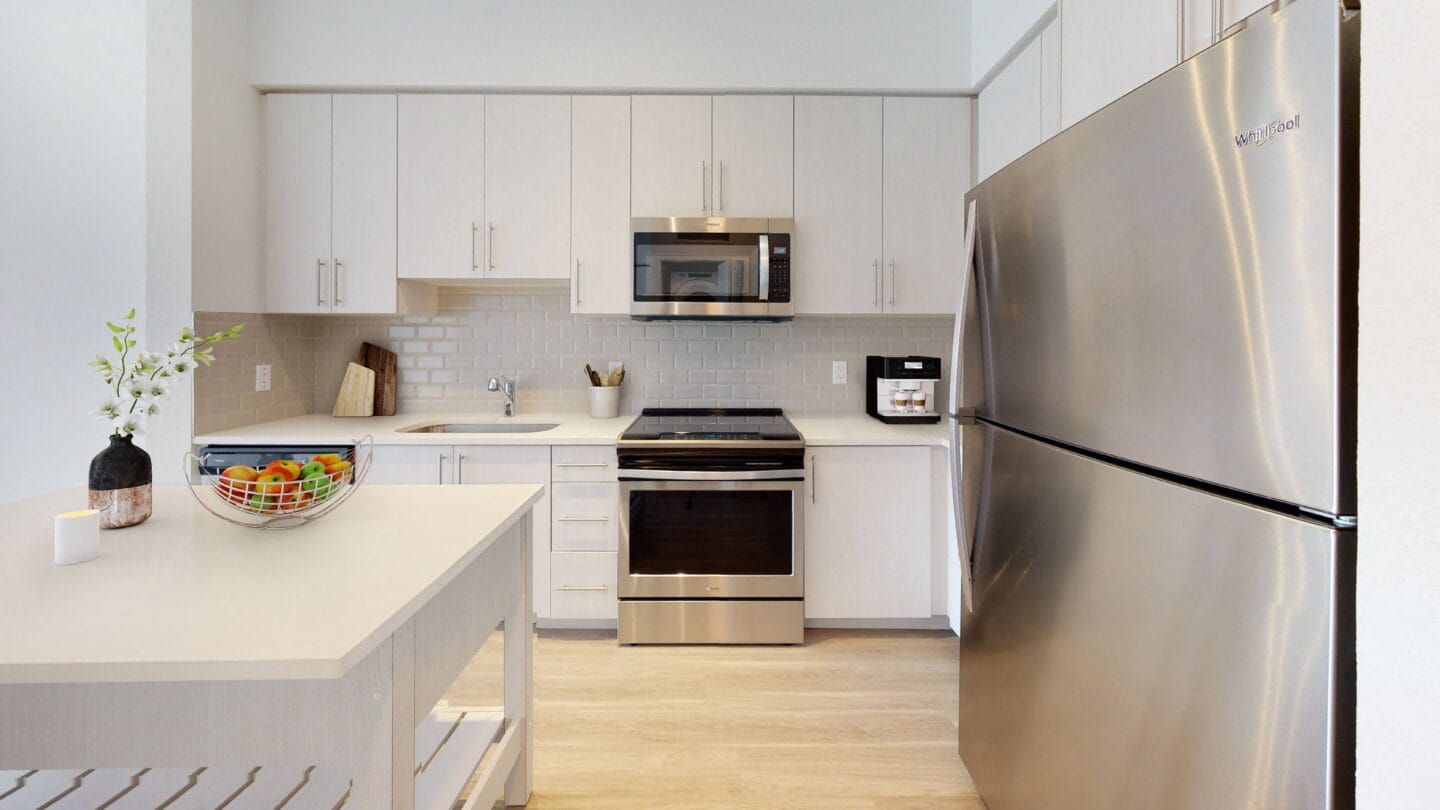 a kitchen with stainless steel appliances and white cabinets