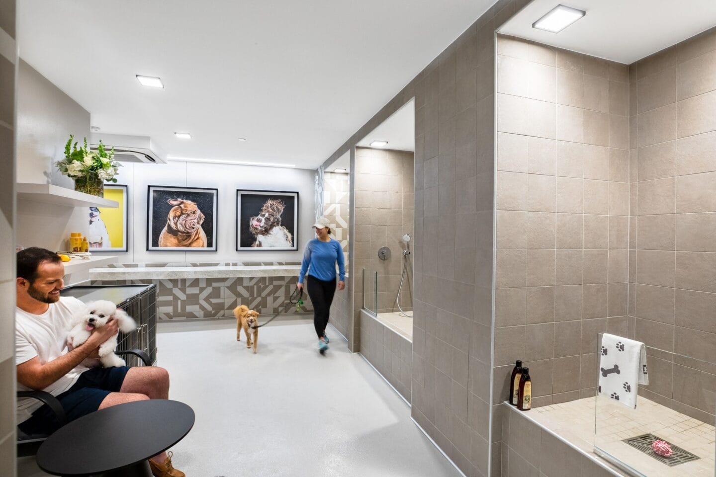 a man sitting in a chair in a bathroom with a bathtub and shower and a woman  at The Sterling at Regent Square, Houston, TX