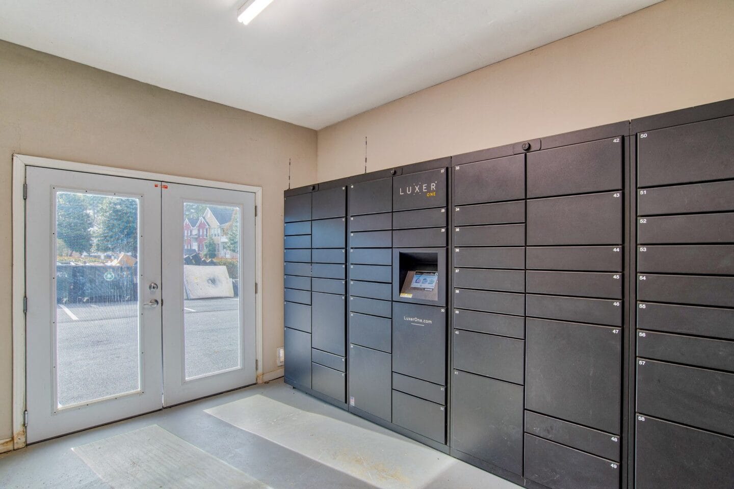 a lockers in a room with a door and a glass door