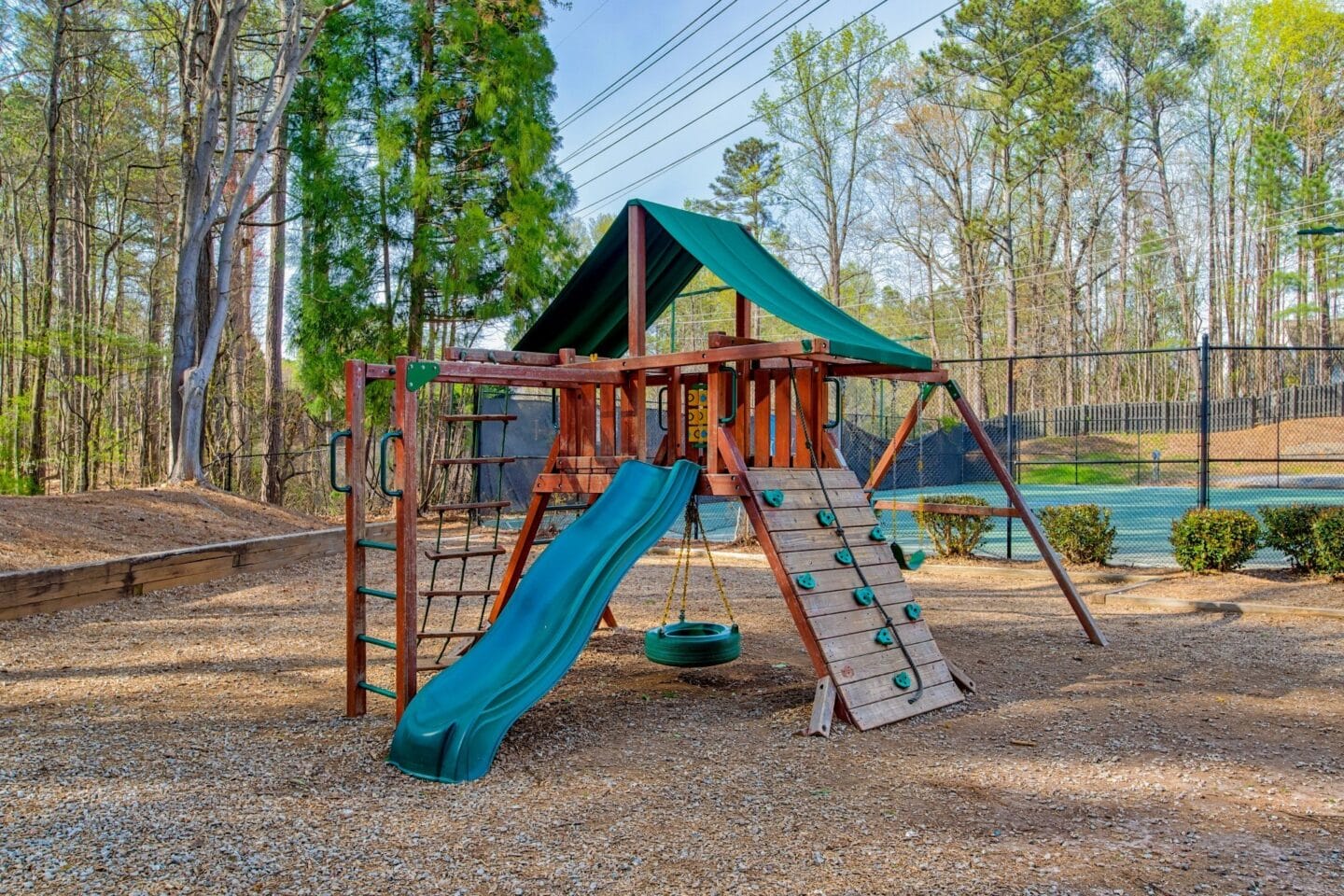 a swing set with a slide in a park