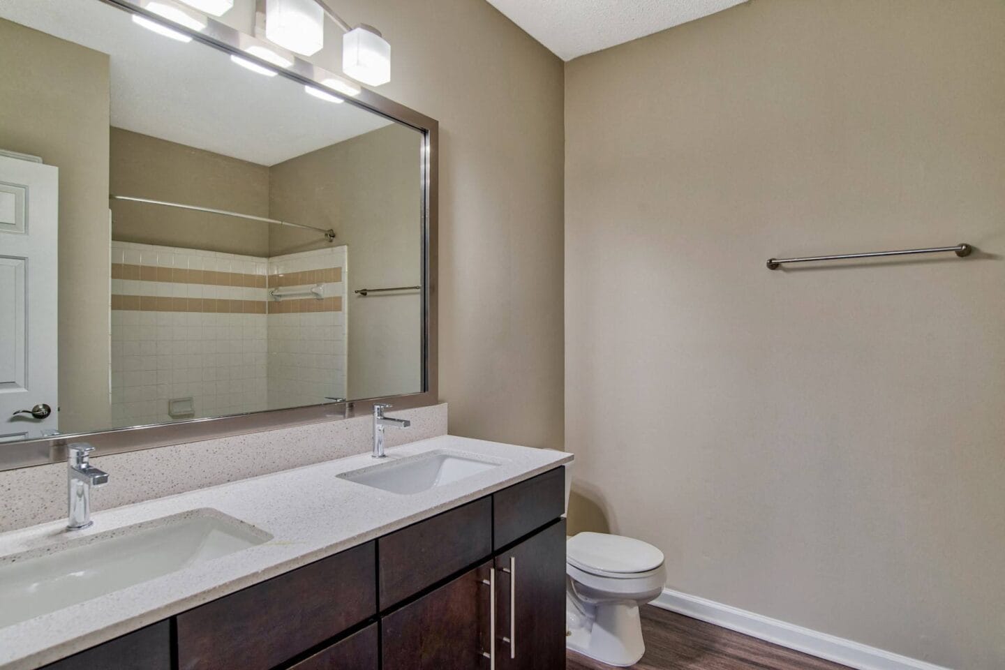 the choices apartments bathroom with toilet sink and mirror