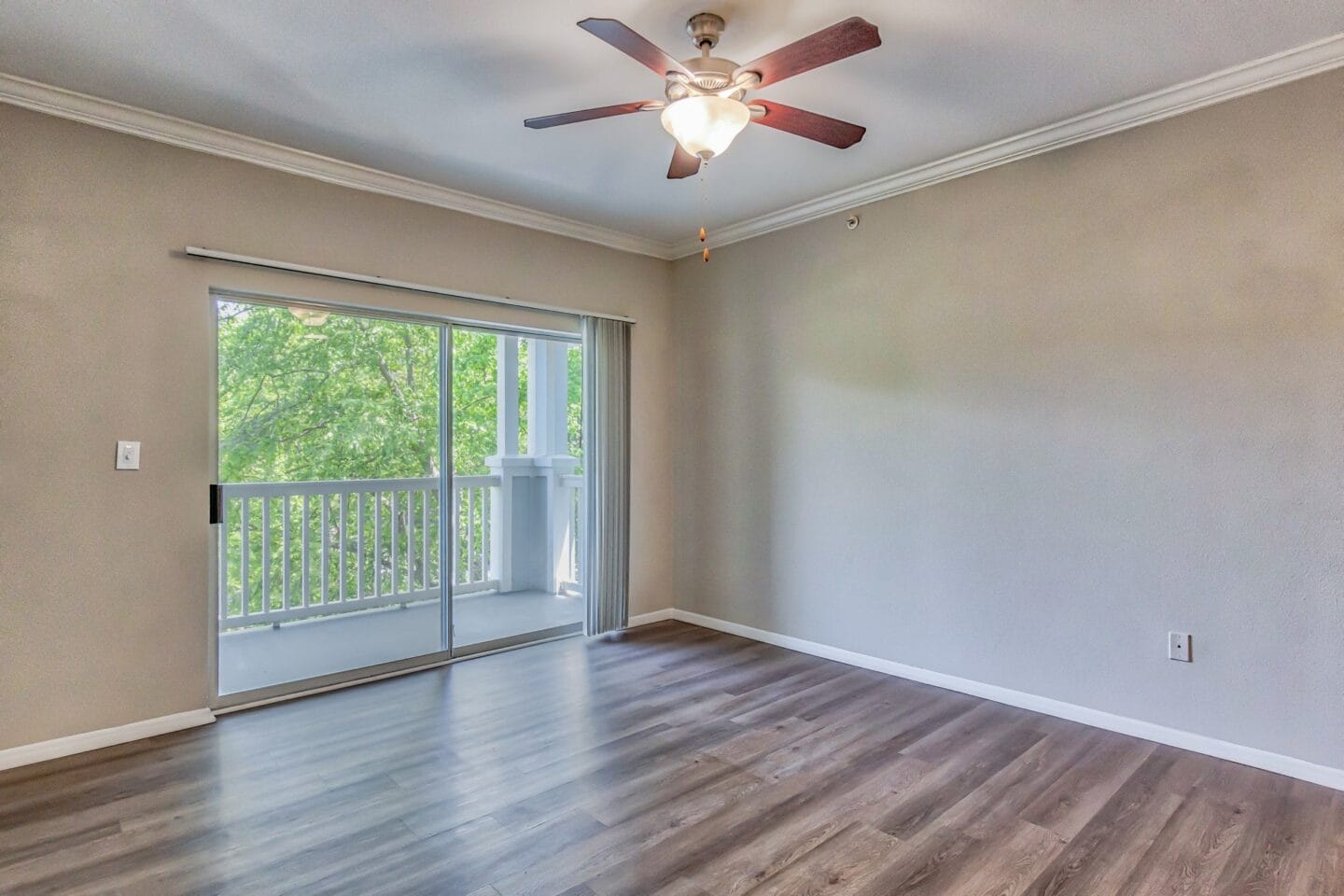 a bedroom with a sliding glass door and a ceiling fan