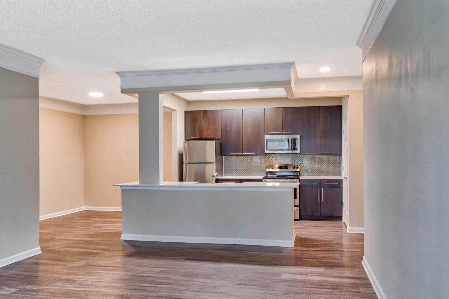 a kitchen with a large island and a stove top oven