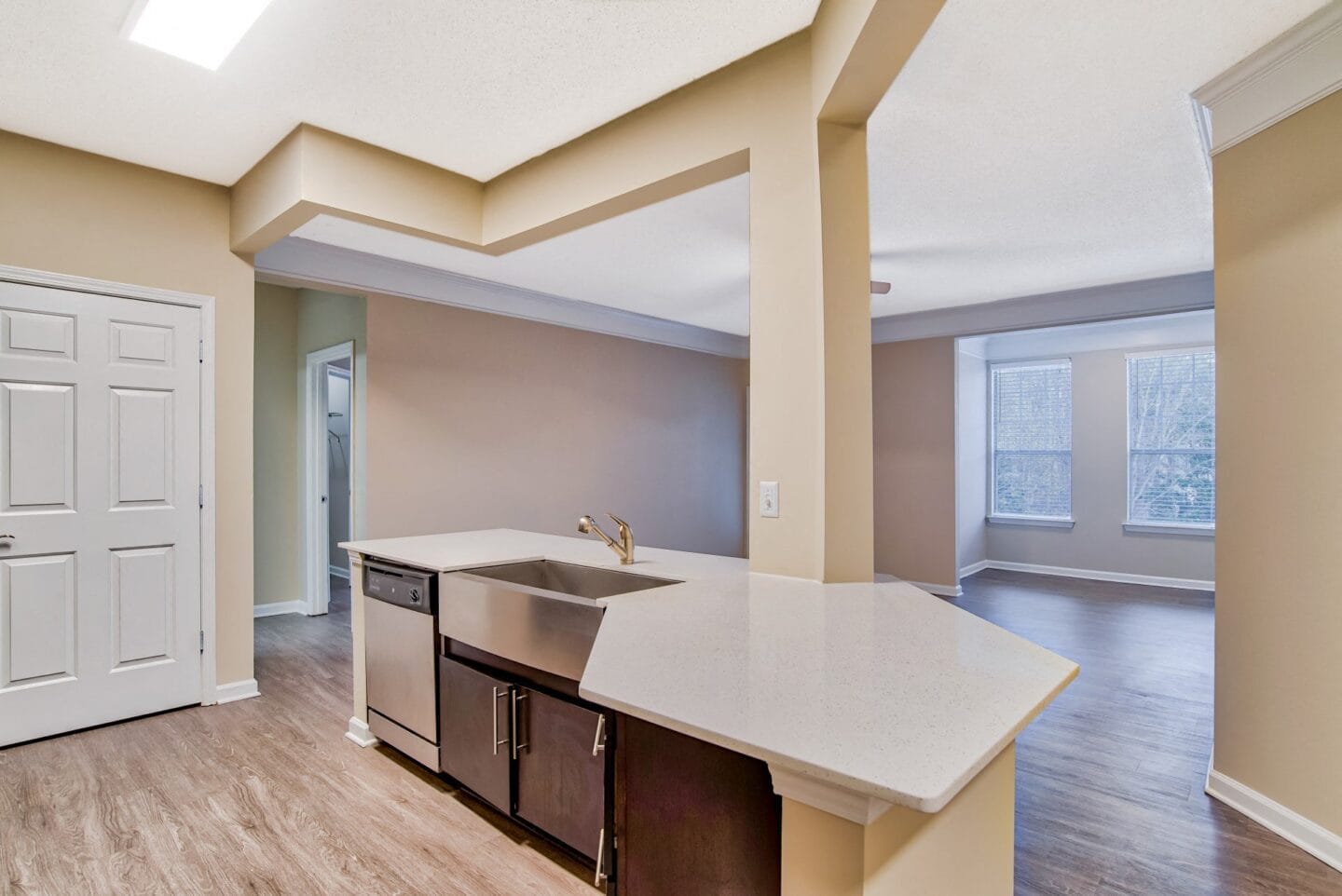 a kitchen with an island with a sink and a dishwasher