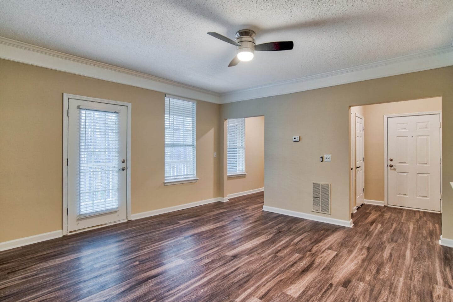 a living room with hardwood floors and a ceiling fan