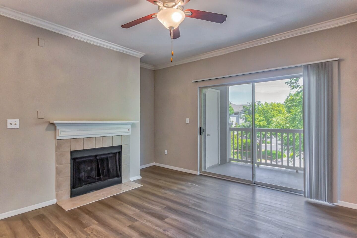 A living room with a fireplace and a sliding glass door