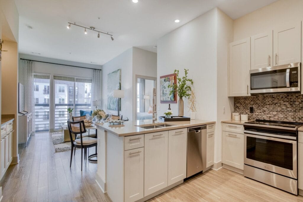 Stunning kitchens feature quartz countertops and tiled backsplash at Windsor Mystic River, Massachusetts, 02155