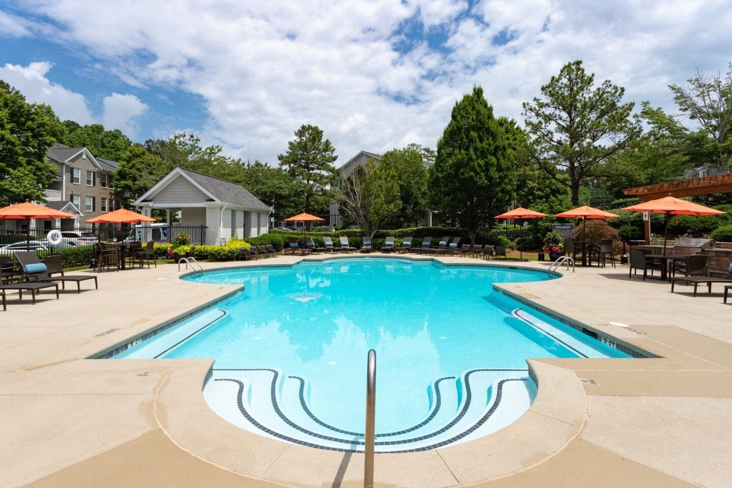 Tables and chairs by pool at Windsor Johns Creek, Johns Creek, GA