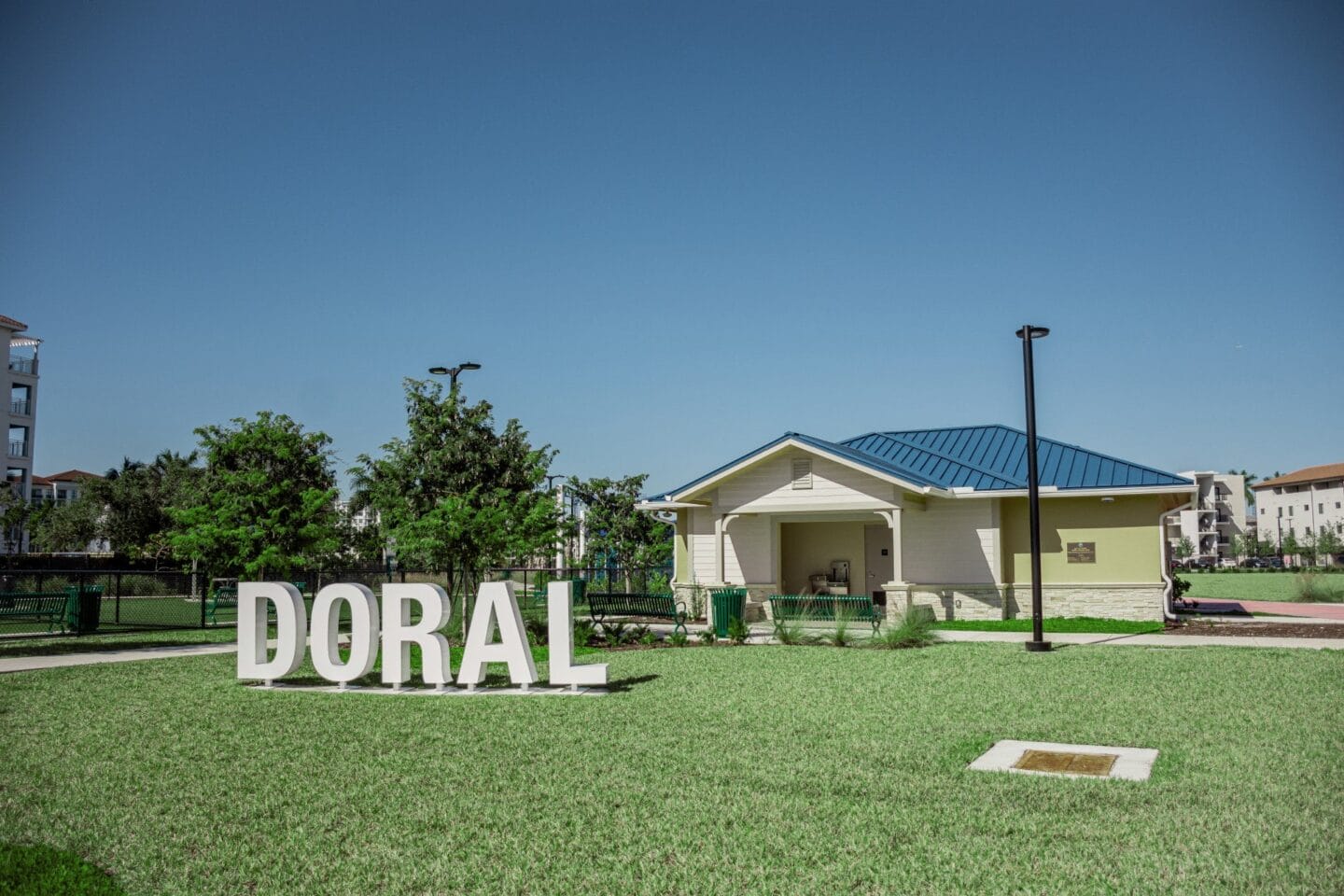 a sign that reads doral with a park facility in the background