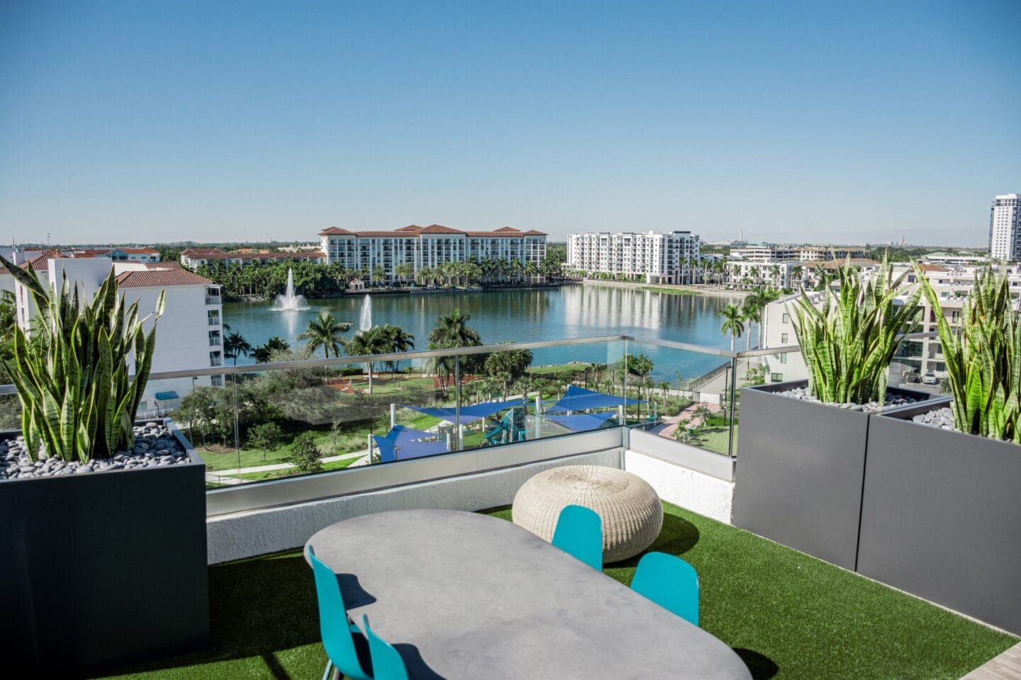 a balcony with a table and chairs and a view of a lake