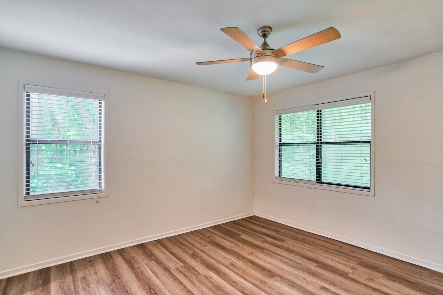 Bedroom with a ceiling fan and two windows at Windsor Peachtree Corners, Peachtree Corners, GA