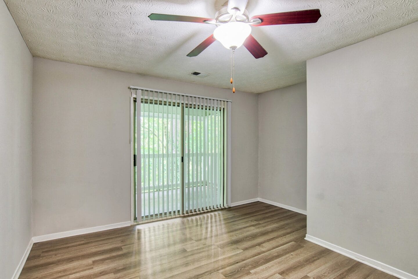 A bedroom with a ceiling fan and a window at Windsor Peachtree Corners, Peachtree Corners, GA