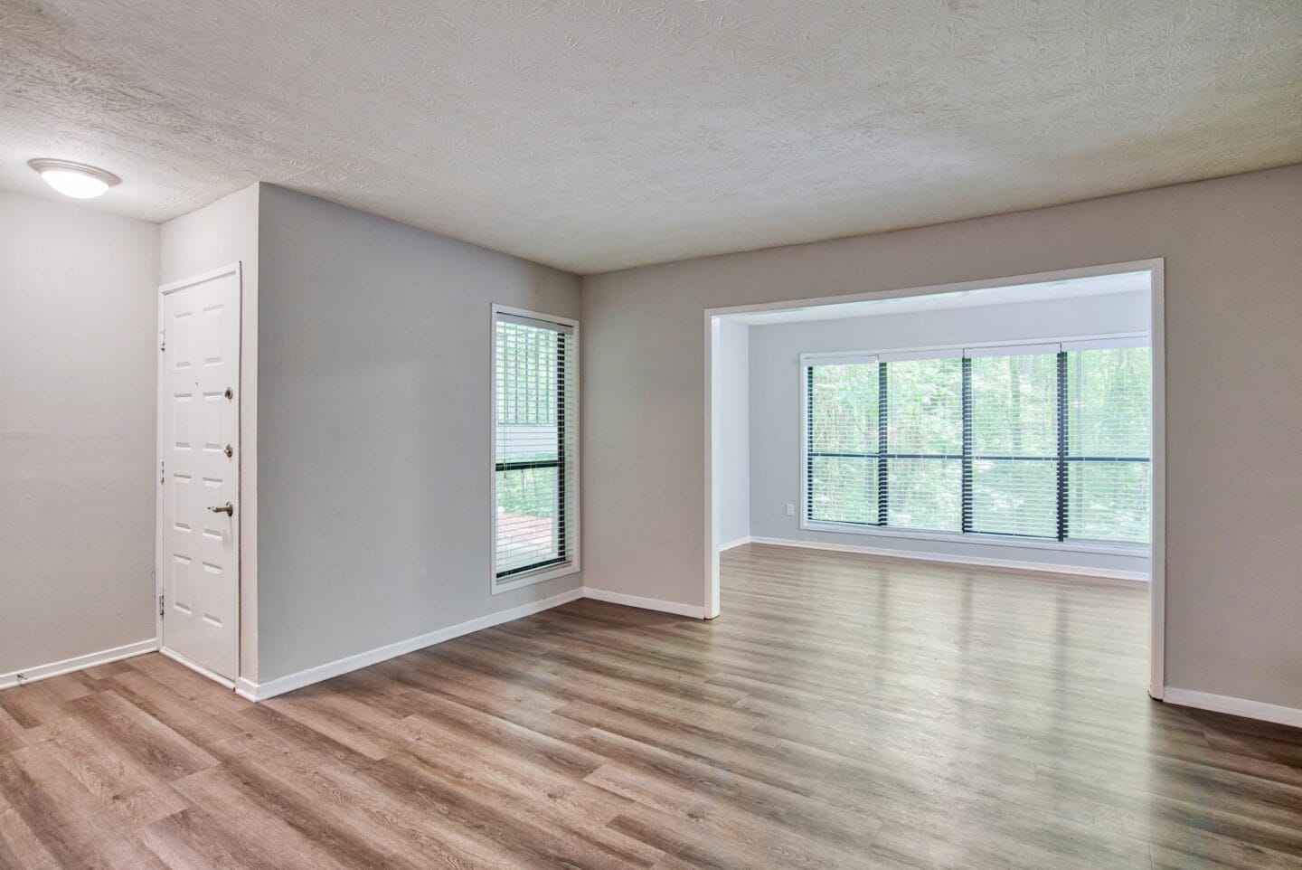 Living room with a large window at Windsor Peachtree Corners, Peachtree Corners, GA