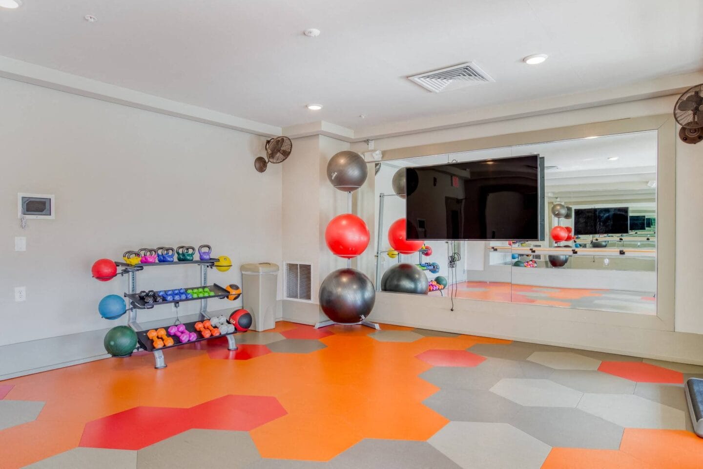 Private yoga studio, brightly colored, with weights and equipment