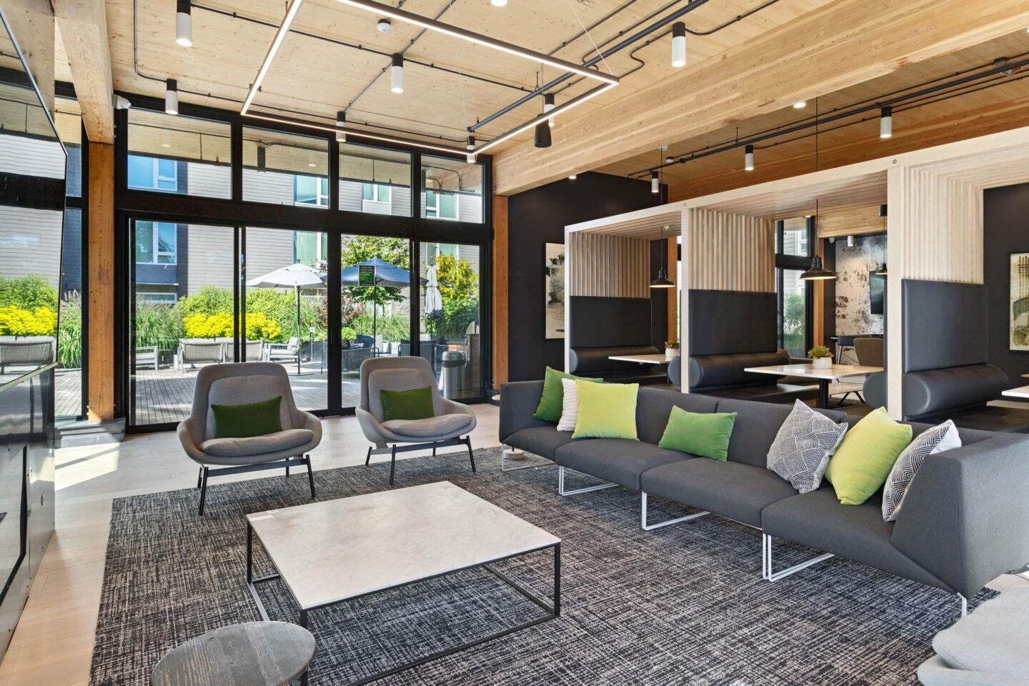 A modern lounge with a grey sofa and a coffee table at Windsor Totem Lake, 11723 NE 117th Ct, Kirkland, WA 98034.