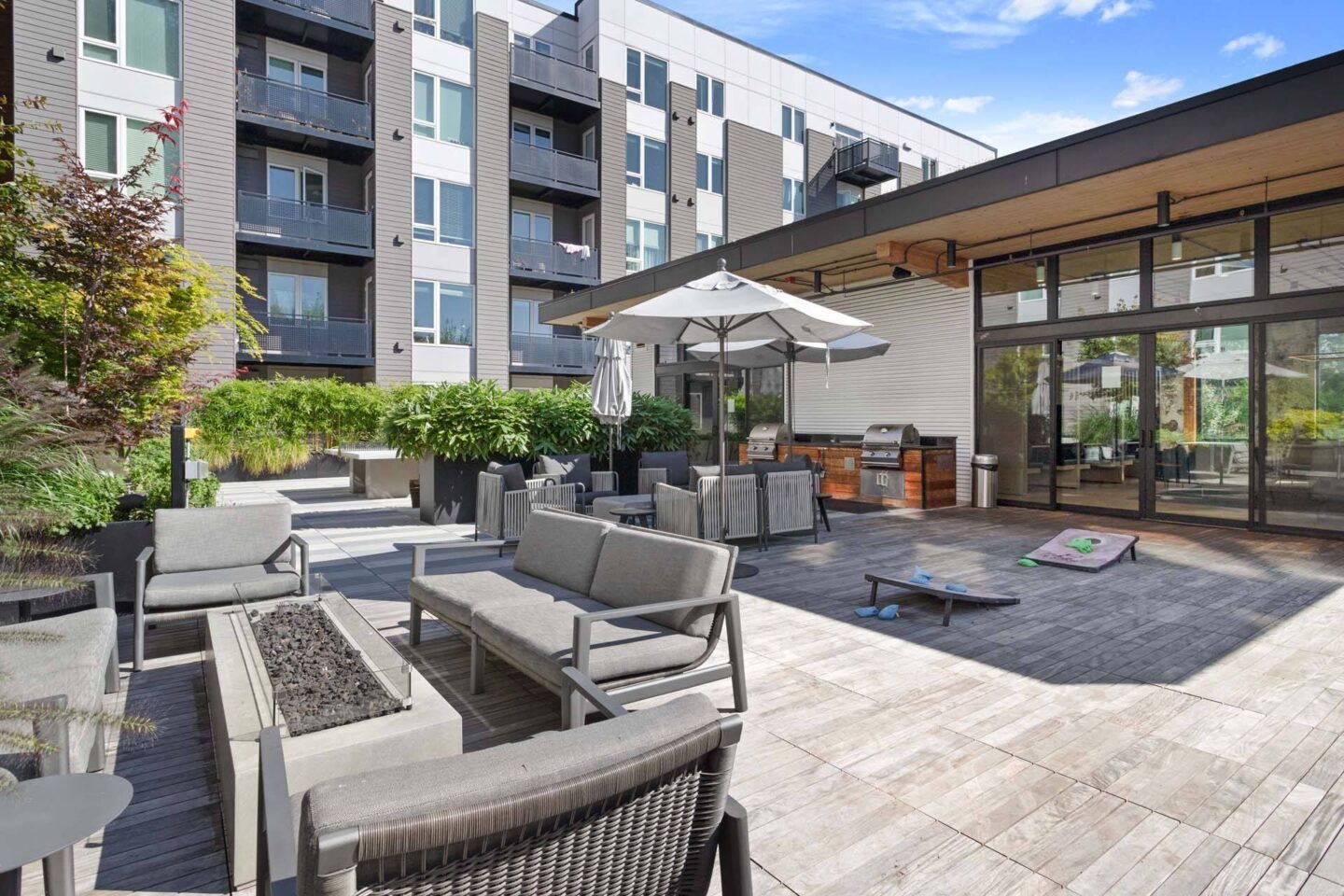 A patio with a table and chairs and a building in the background at Windsor Totem Lake, 11723 NE 117th Ct, Kirkland, WA 98034.