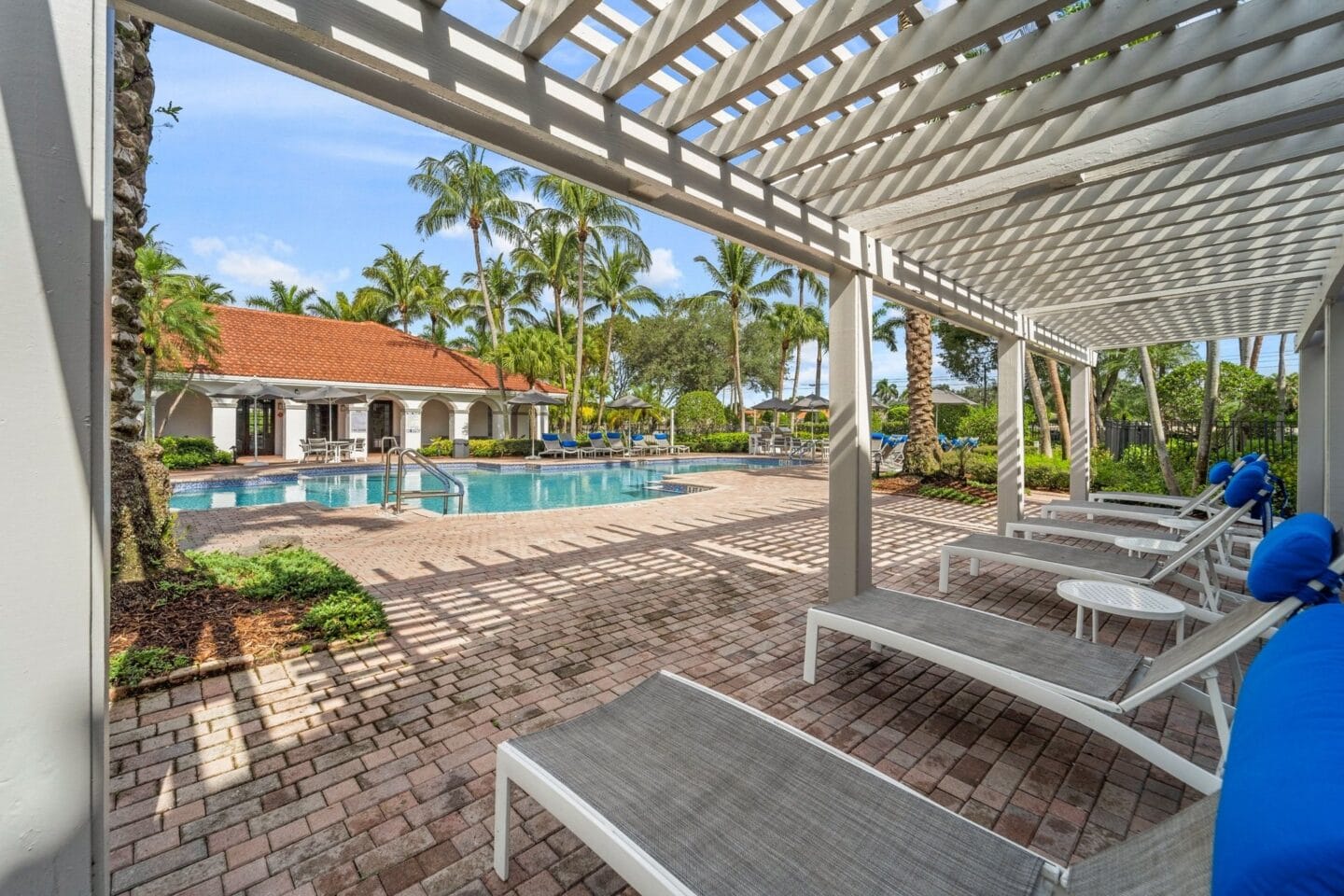 View of the pool from under the pergola at Windsor Coral Springs, Coral Springs, FL